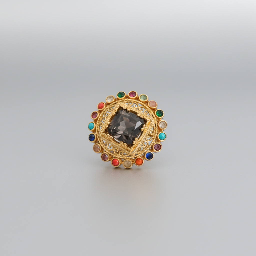A product photo of a vintage brooch displayed on a white catalog sheet inside a web browser. The brooch is a circular gold-toned piece decorated with red, green, and turquoise stones, held by a white tag marked '141'.