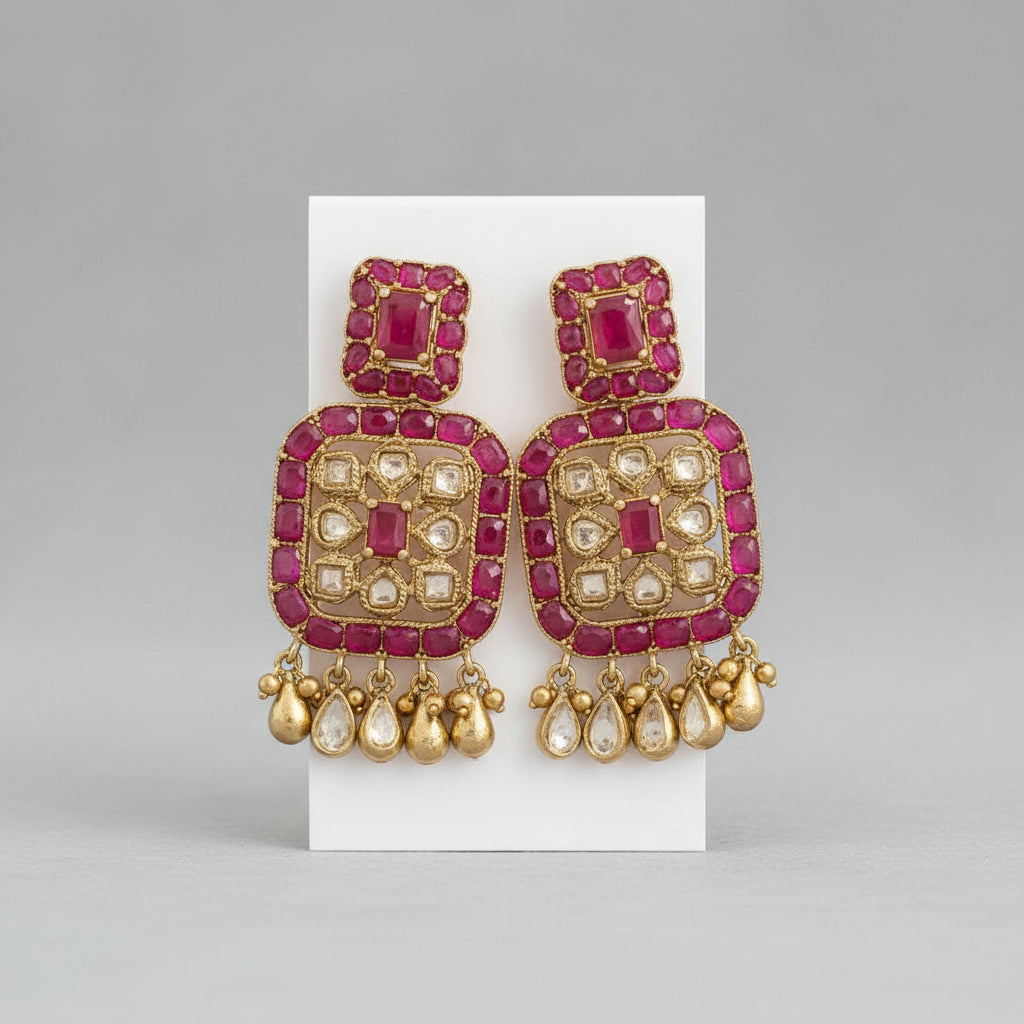 A pair of pink and gold statement earrings displayed on a white card, shown within a screenshot of a Google Sheets document.