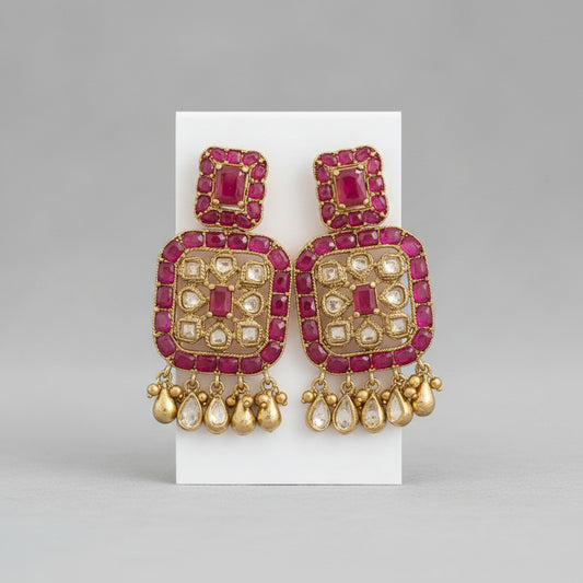 A pair of pink and gold statement earrings displayed on a white card, shown within a screenshot of a Google Sheets document.
