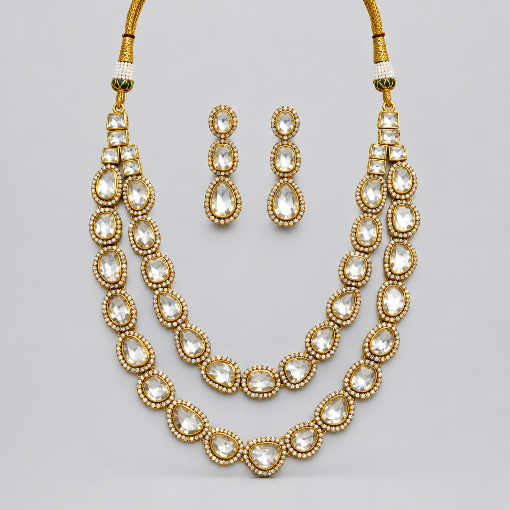 A necklace set displayed on a light gray background, featuring a silver-toned necklace with gold and white stone accents, a matching pendant, and a pair of dangling earrings. The image is shown within a web browser interface with navigation bars and tabs visible.